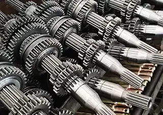 Close-up of precision-machined gearbox gears, illustrating XT-AGRO's guarantee of 10-year genuine spare parts availability for all dealers.