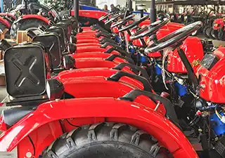 Fleet of customized red farm tractors staged for cleaning and SKD packaging, ready for export shipment to global markets.